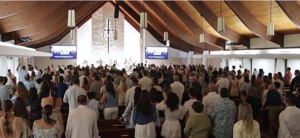 The congregation of Christchurch Miami standing in worship